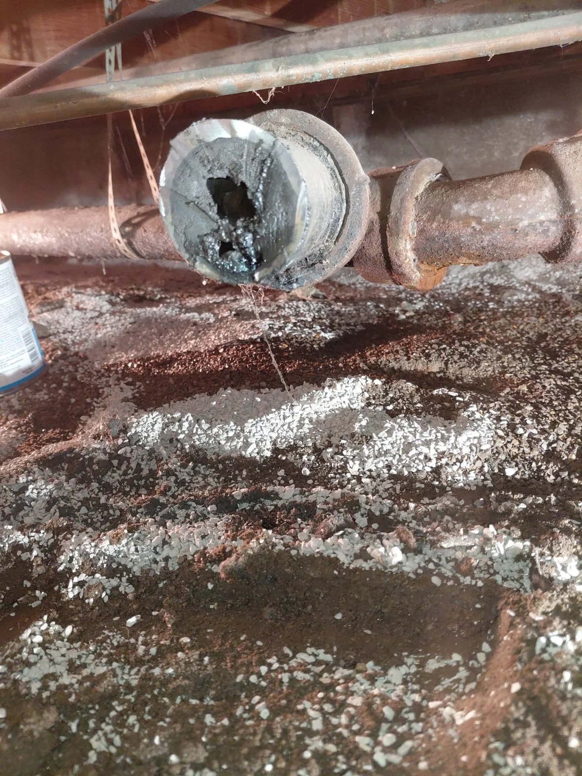 Existing sewer drain cleanout with visible buildup prior to cleaning